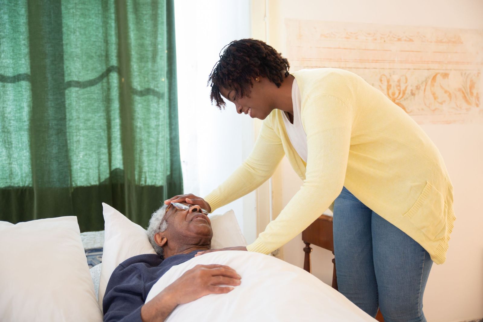 Woman caring for an older man at home